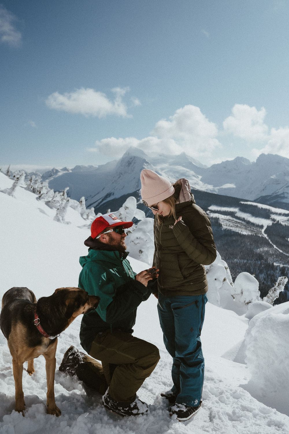 A marriage proposal takes place on a snow-covered mountain peak with stunning alpine views.