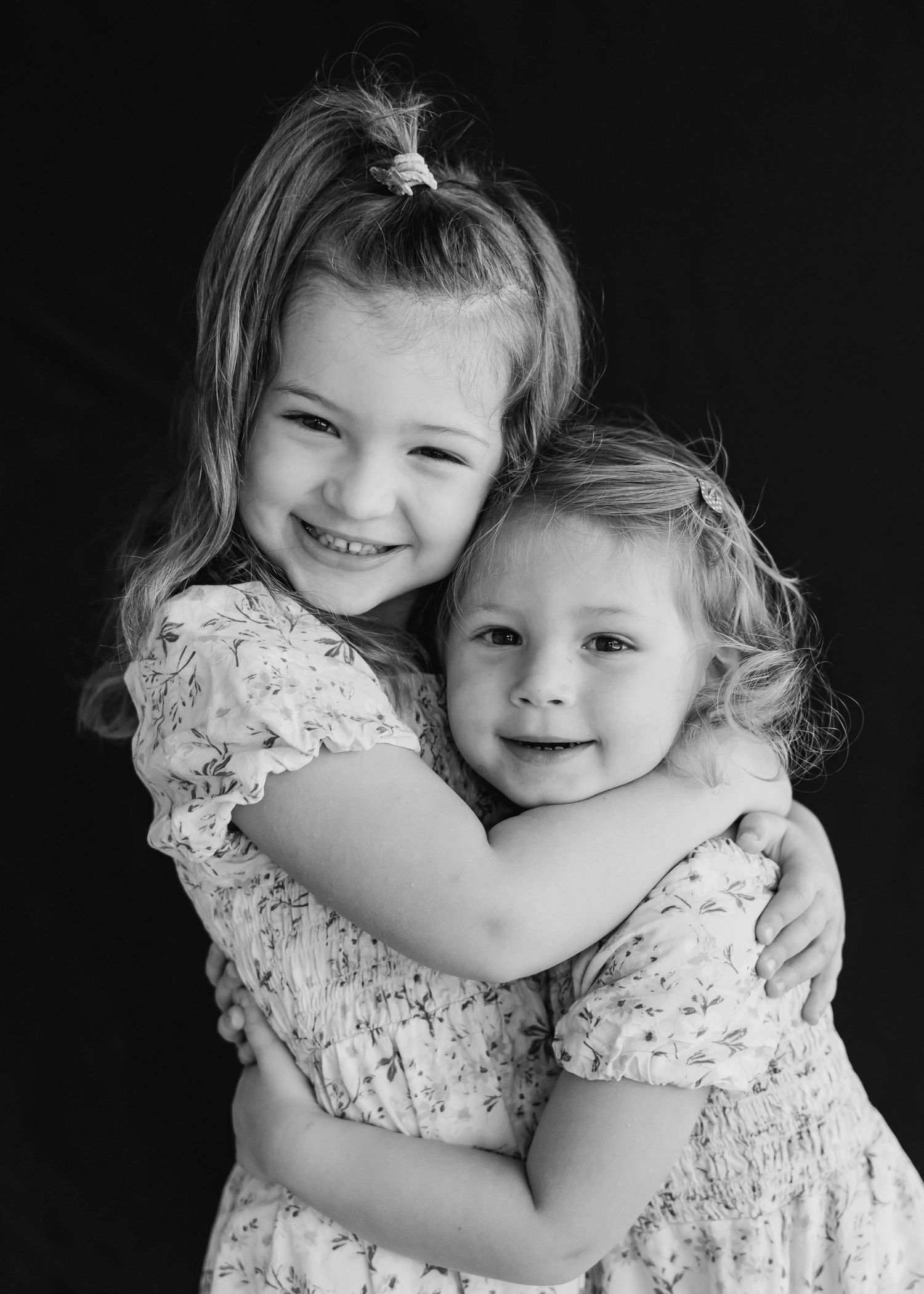 Inclusive sibling school portrait with soft backdrop and warm lighting
