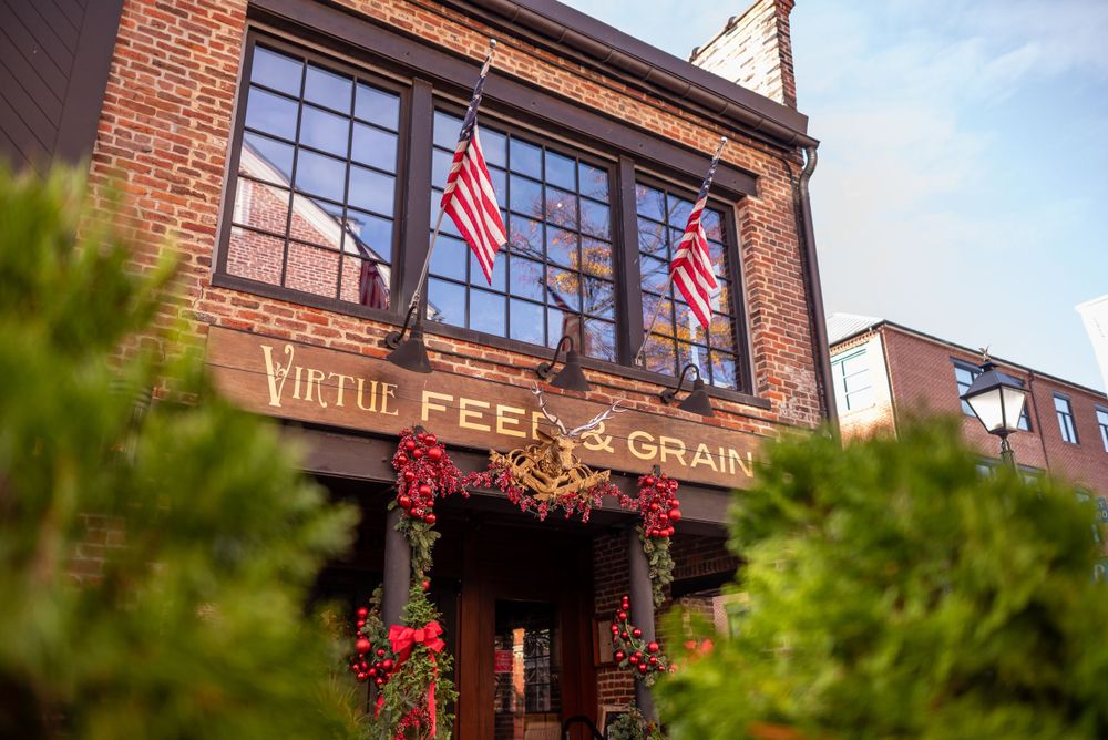Historic Feed & Grain building with American flags and red holiday decorations.