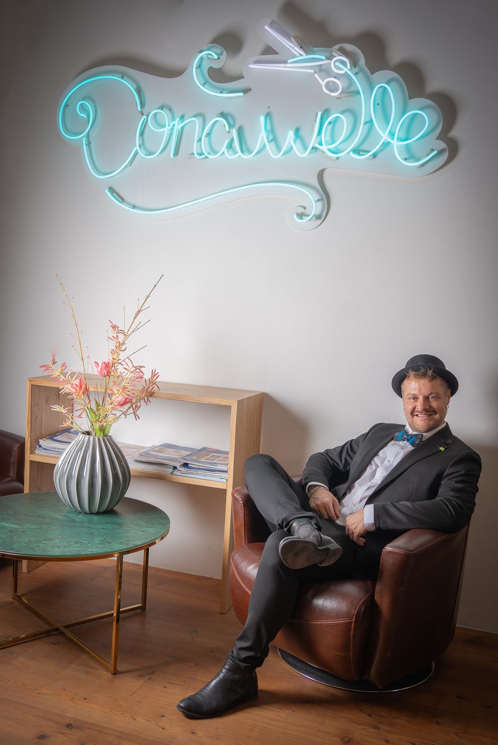 Businessfotografie, Business Projects. Vintage-styled setting with leather chair and turquoise neon sign.