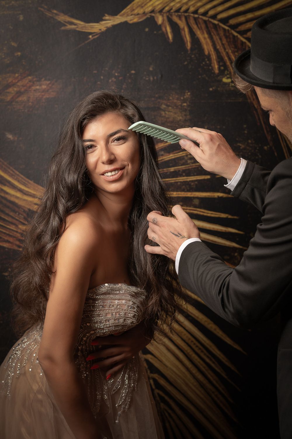 Businessfotografie, Business Projects. A glamorous photo shoot features a sparkling dress against a golden palm leaf backdrop.