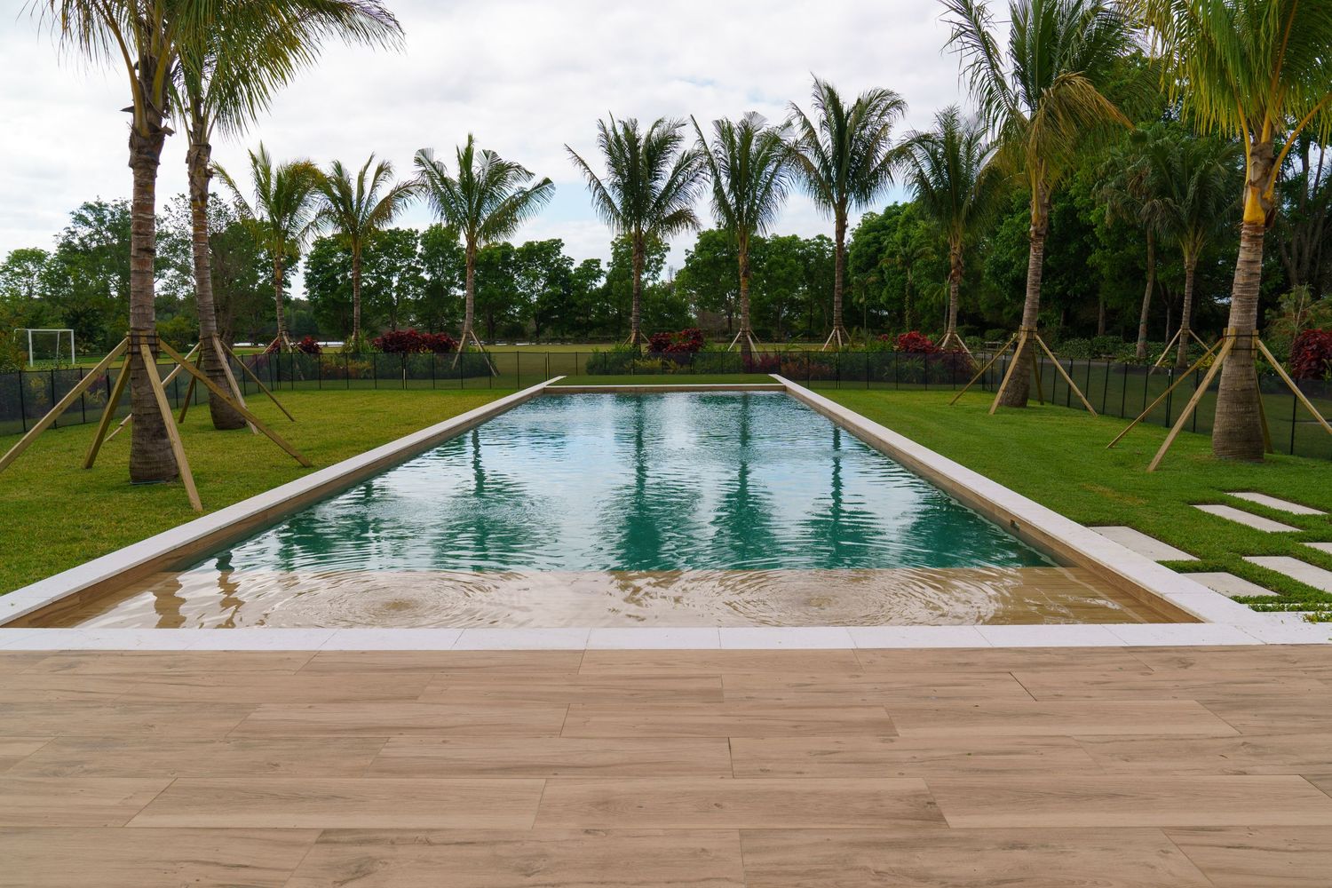 Bright exterior of a South Florida home with wide-angle view and natural light, professional real estate listing photo by SRX Media