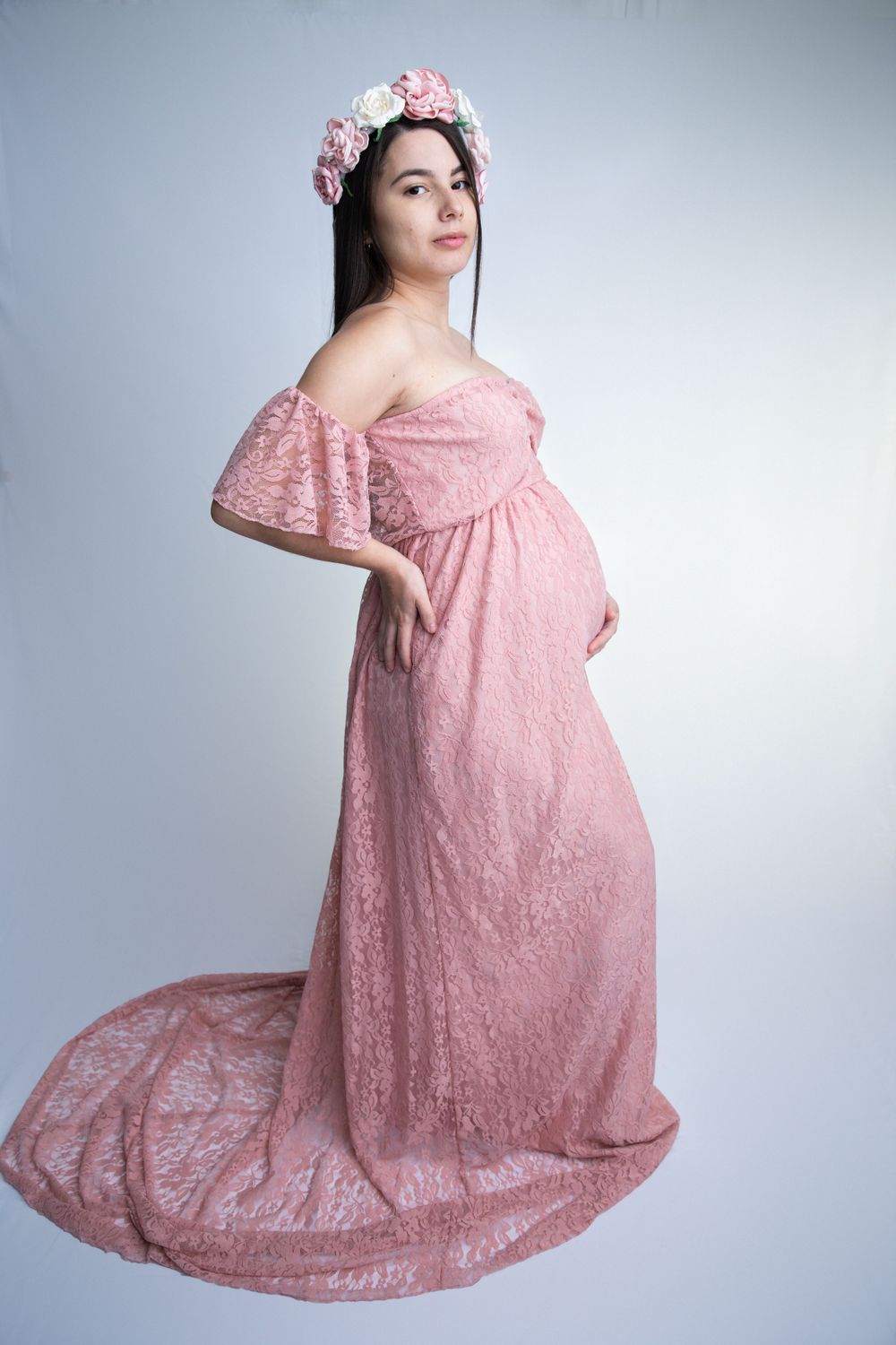 Pregnant woman in pink lace gown with floral crown during Central Florida maternity session.