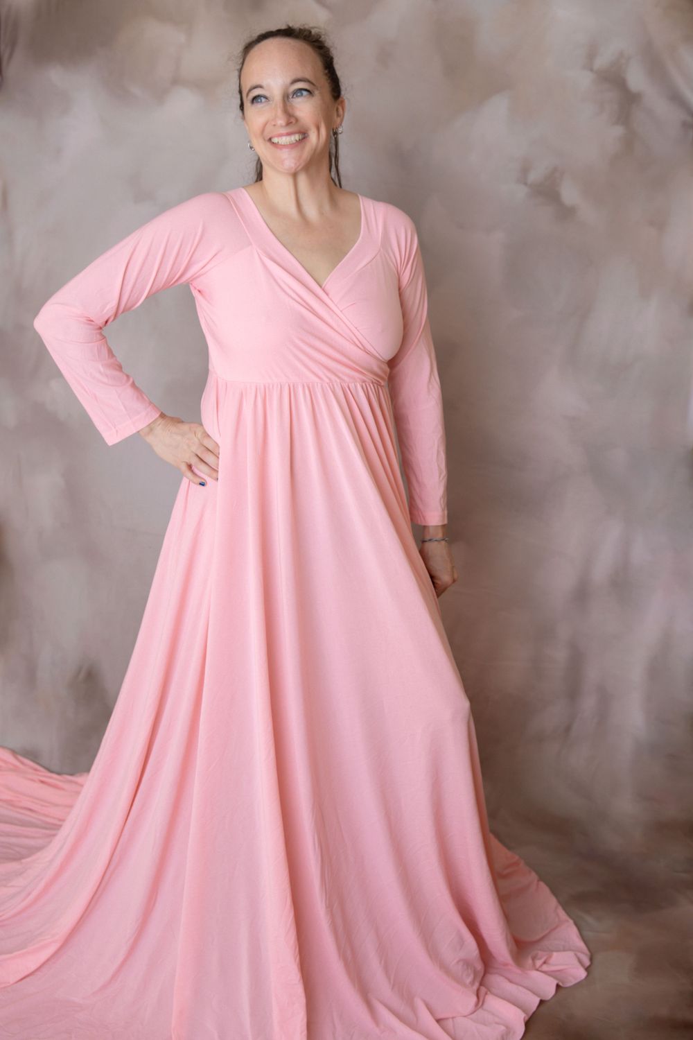 Pregnant woman in flowing pink gown during maternity photography session in Orange City Florida.