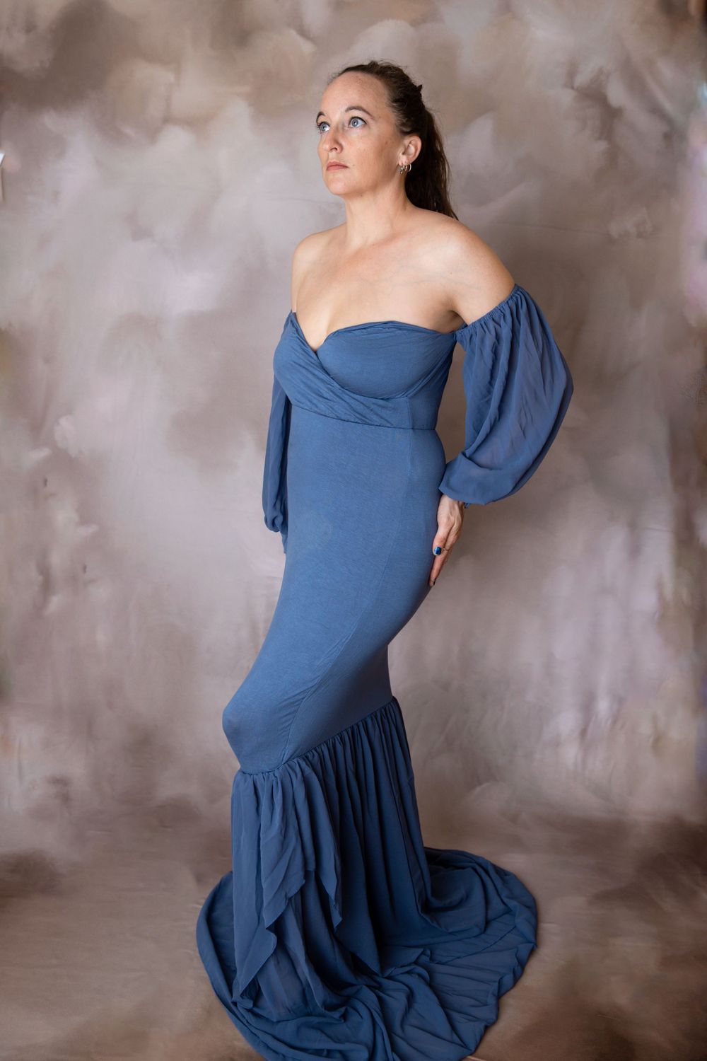Pregnant woman in dusty blue off-shoulder gown during Central Florida maternity session.