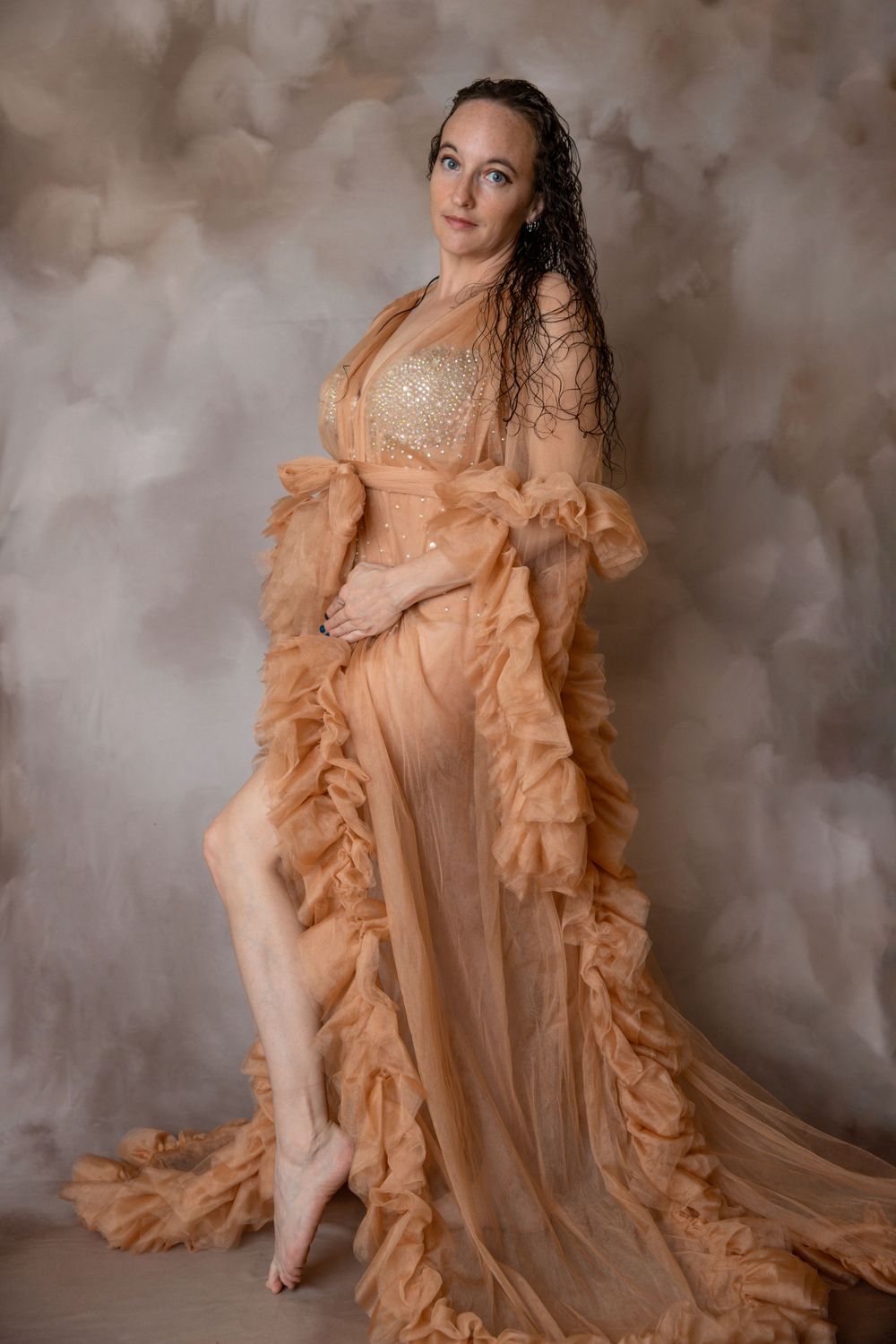 Pregnant woman in tulle gown during maternity photography session in Orange City Florida.