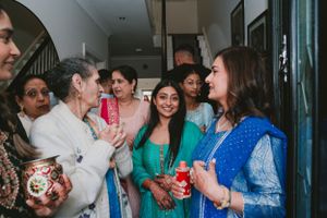 Guests enjoying a festive gathering in traditional Indian attire.