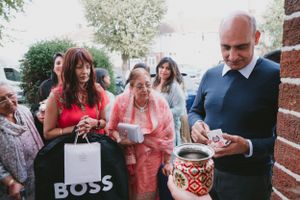 People gathered outdoors with shopping bags and decorated containers.