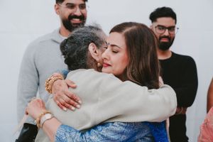 Emotional embrace shared between family members during a wedding celebration.