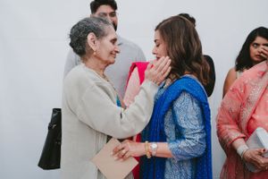 Touching moment of affection between family members at a traditional South Asian celebration.