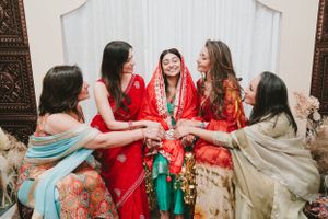 Wedding celebration showing guests in colorful traditional Indian attire gathered around the central figure.