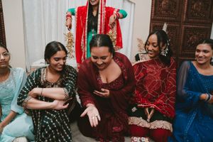 Wedding celebration scene with guests in colorful traditional attire sitting together and sharing joyful moments.