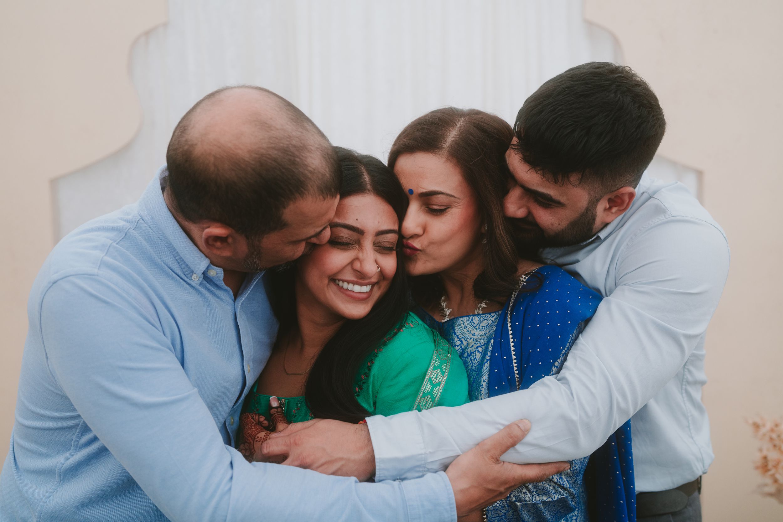 Warm family embrace showing affection and celebration in formal attire.