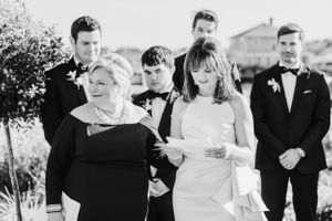 Black and white photo of a wedding ceremony with attendees in formal attire.