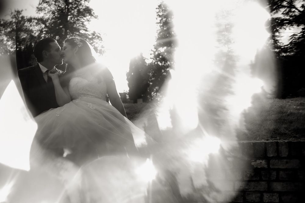Artistic black and white wedding photo with ethereal smoke effects.