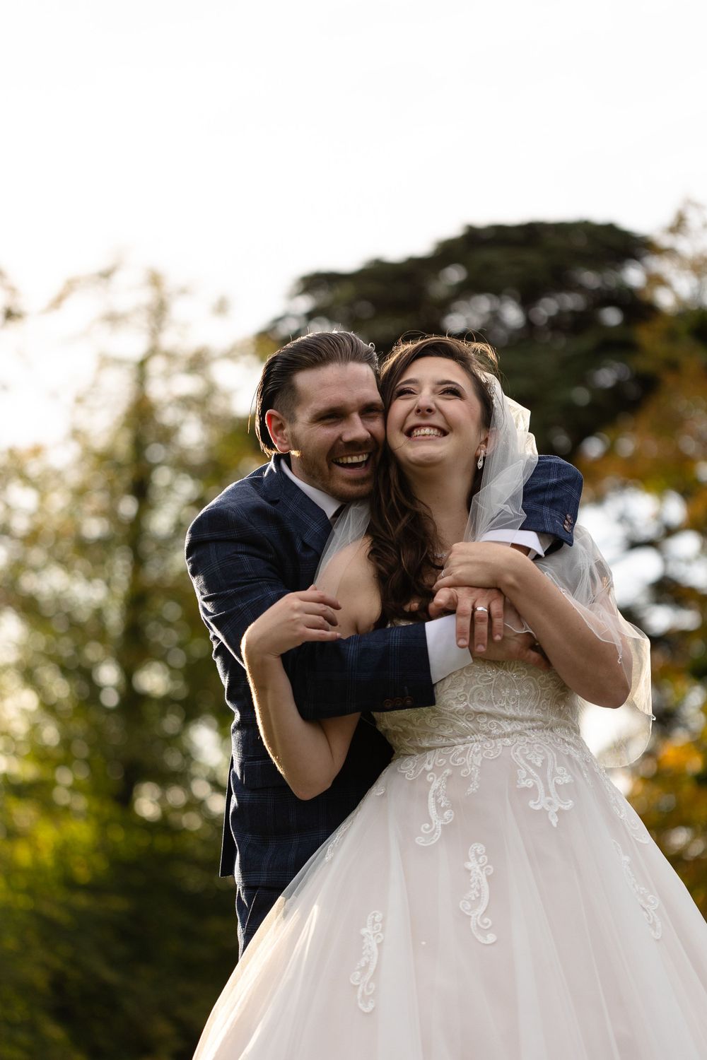 Joyful embrace captured during outdoor wedding photoshoot.