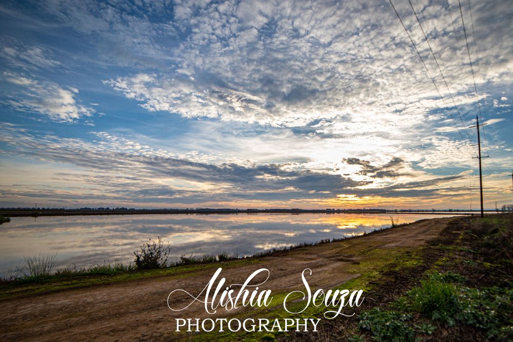 Orange sunset mirrored reflection over northern California rice fields