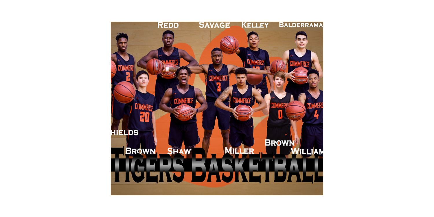 A youth basketball team wearing orange and navy uniforms seated in two rows for a formal team photo.