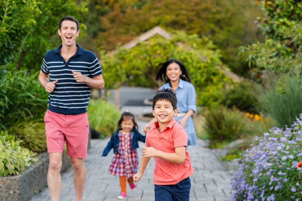 Family running together in the summer at Center for Urban Horticulture.