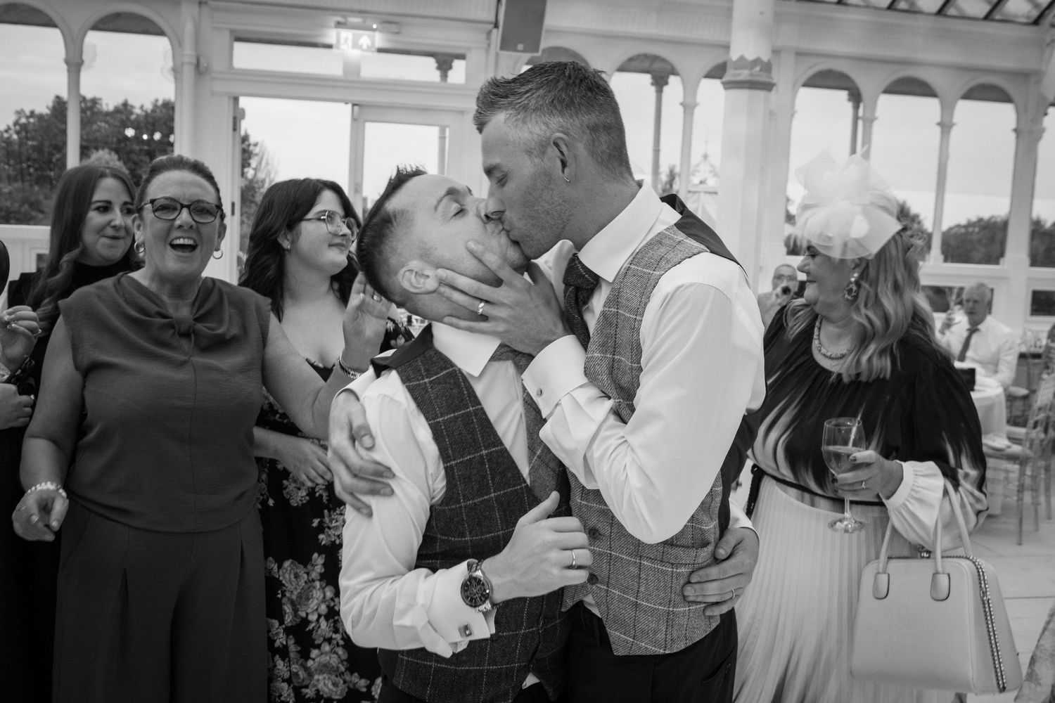 Black and white photos of wedding guests dancing and celebrating.