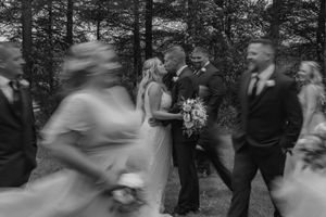 A sequence of black and white photos showing a couple dancing together at an outdoor wedding celebration.