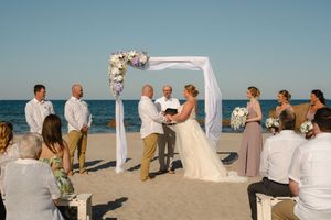 A series of beach wedding ceremony photos showing guests and a white arch against the ocean backdrop.