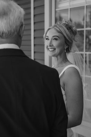 Black and white wedding photo sequence showing a bride in a strapless dress sharing a candid laughing moment outdoors.
