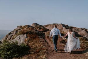 Bride and groom walking holding hands