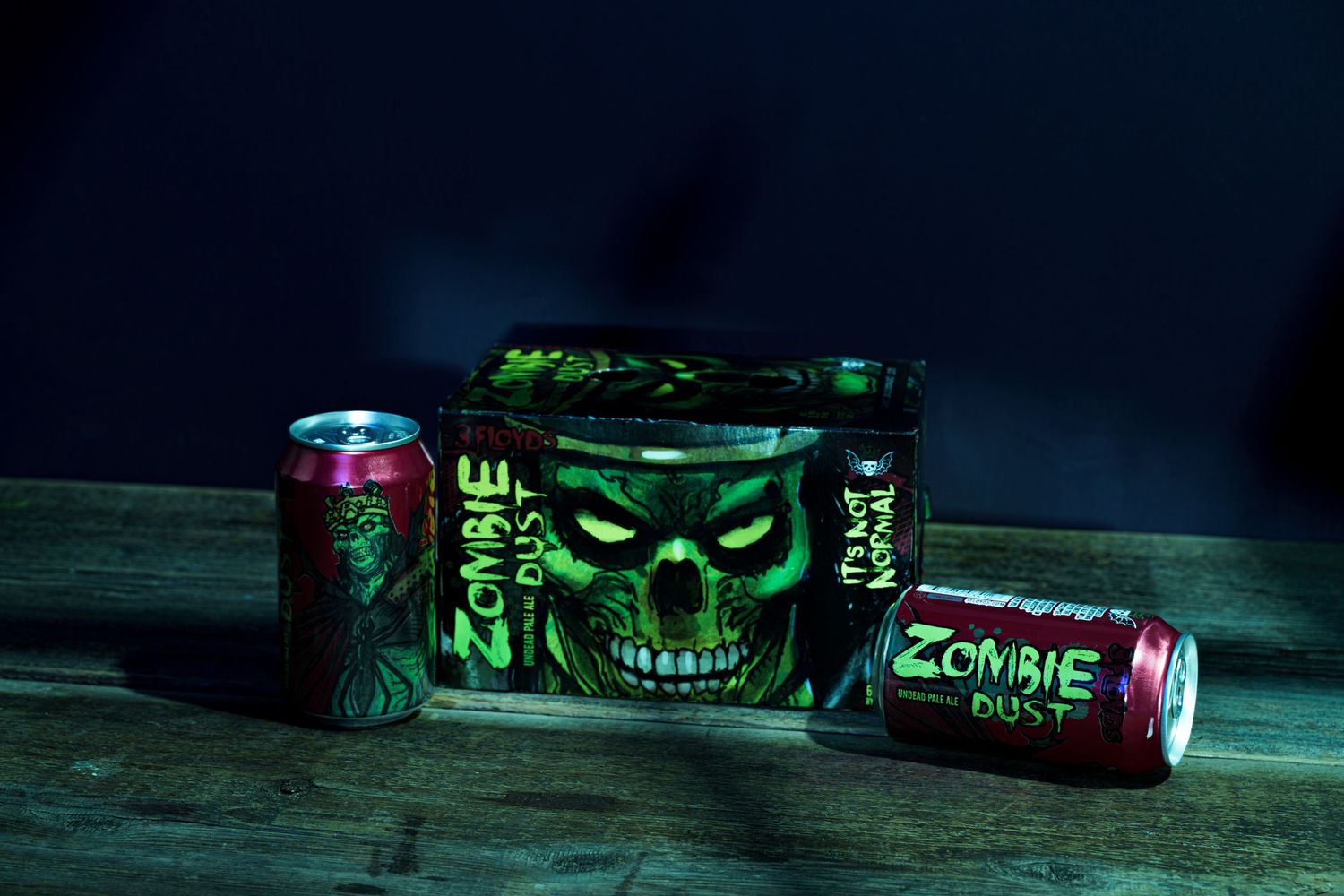 Spooky green energy drink cans with skull designs in dramatic dark lighting.