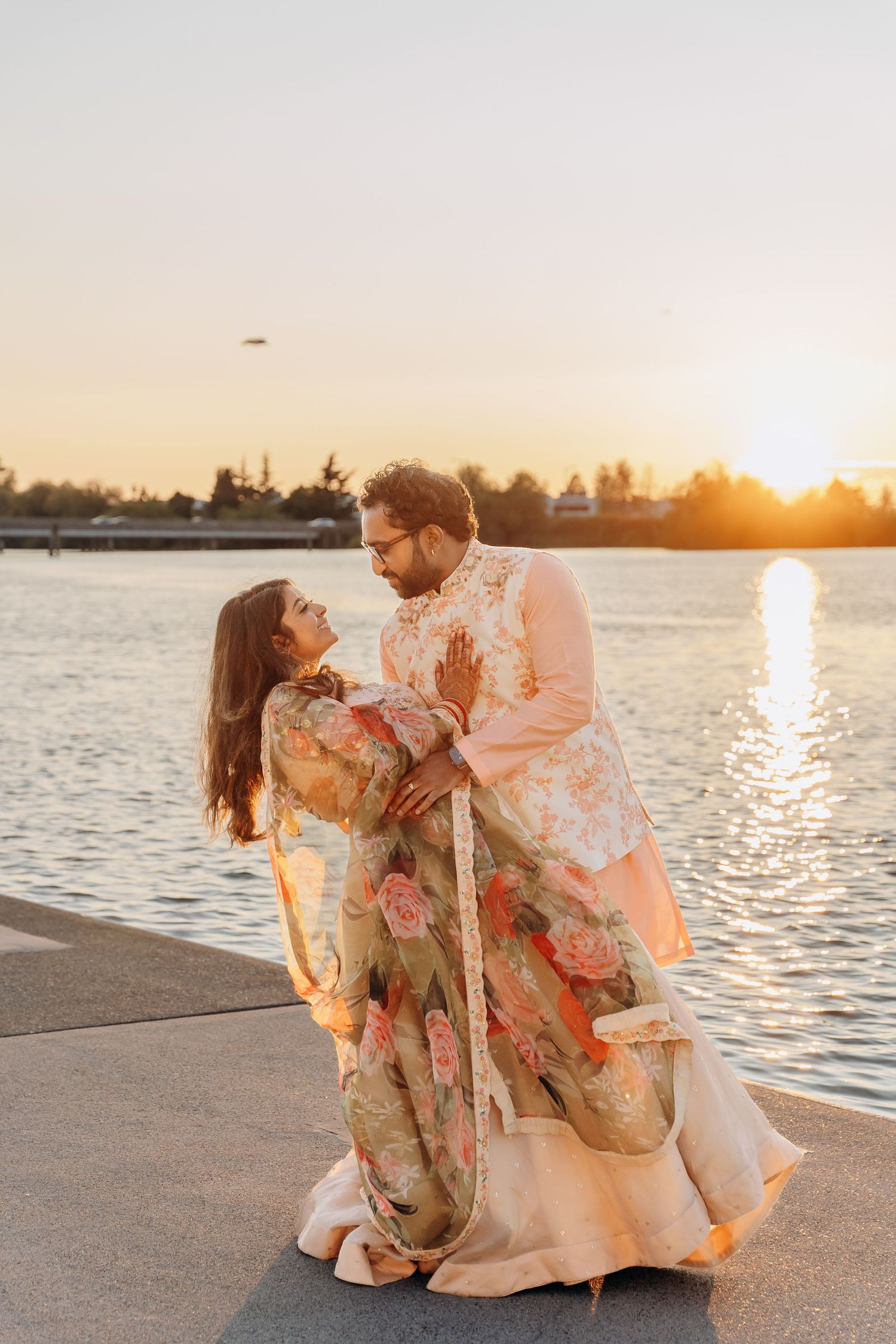 Couple sharing intimate moment in sunlit garden setting with white floral bouquet. UBC Boat House romantic wedding photographer