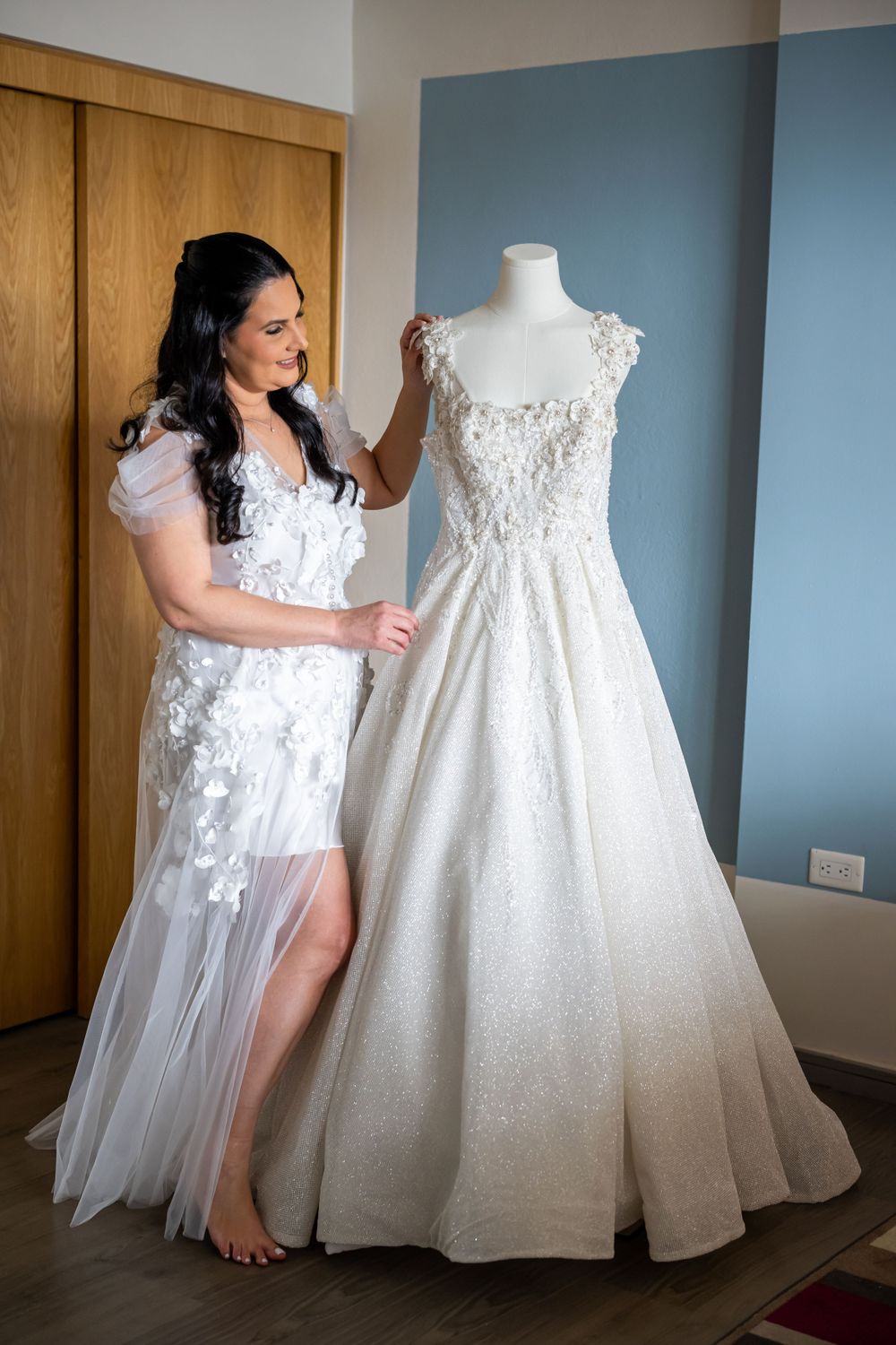Wedding dress on mannequin featuring lace details and full tulle skirt.