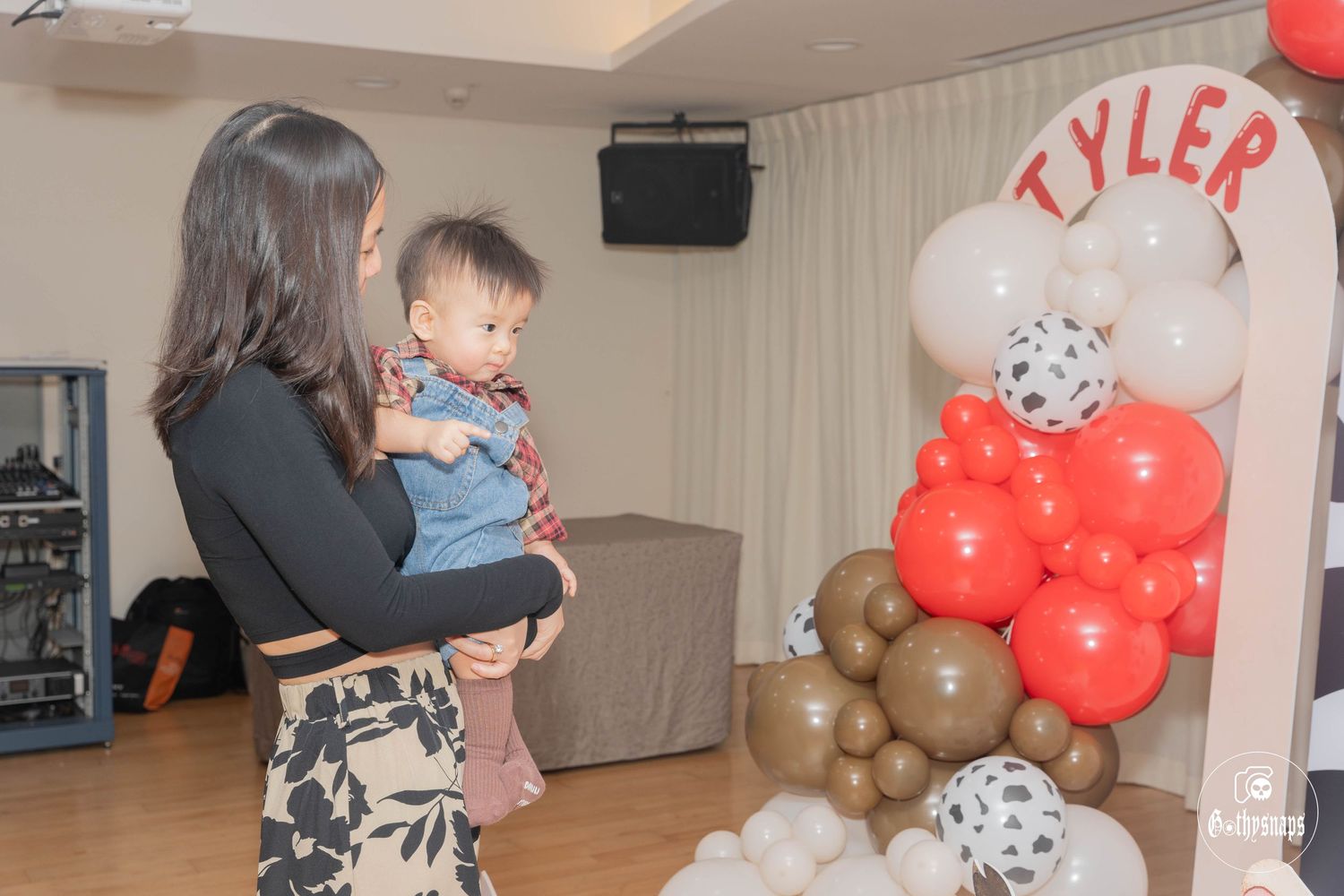 Party celebration with red balloon arrangements spelling out name Tyler.