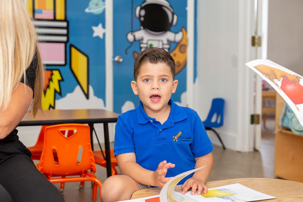 Children engaged in learning activities at blue tables in a vibrant classroom.
Schools photography.