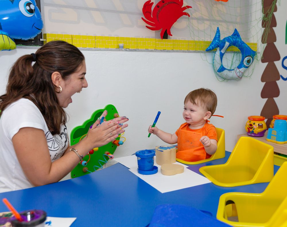 Interactive learning session with children at blue tables in a colorful classroom.
Schools photography.
