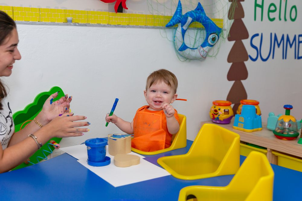 Educational activities taking place at blue tables with colorful wall decorations.
Schools photography.