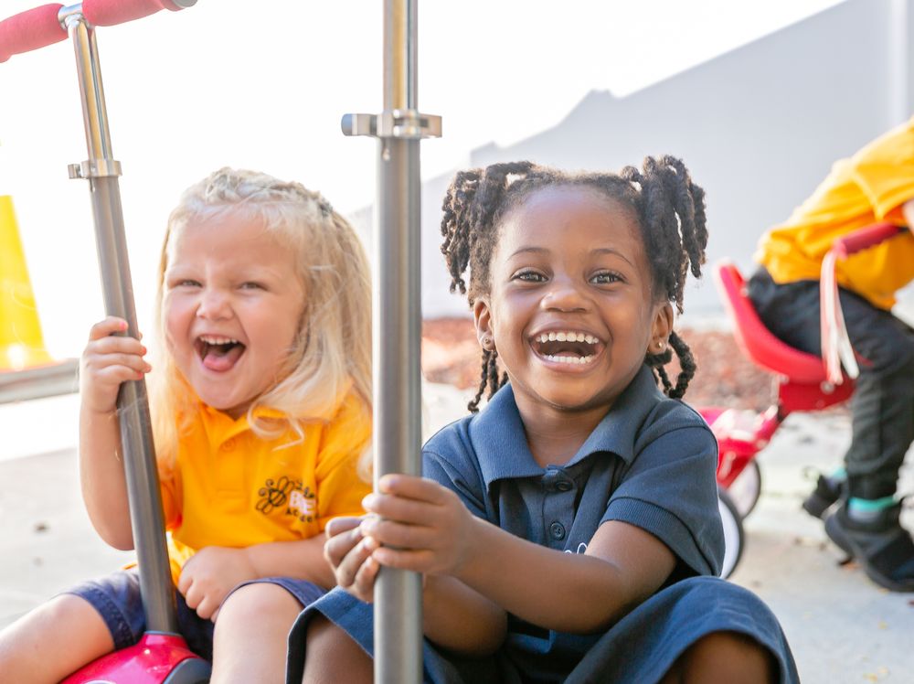 Children playing and laughing together at an outdoor playground.
Schools photography.