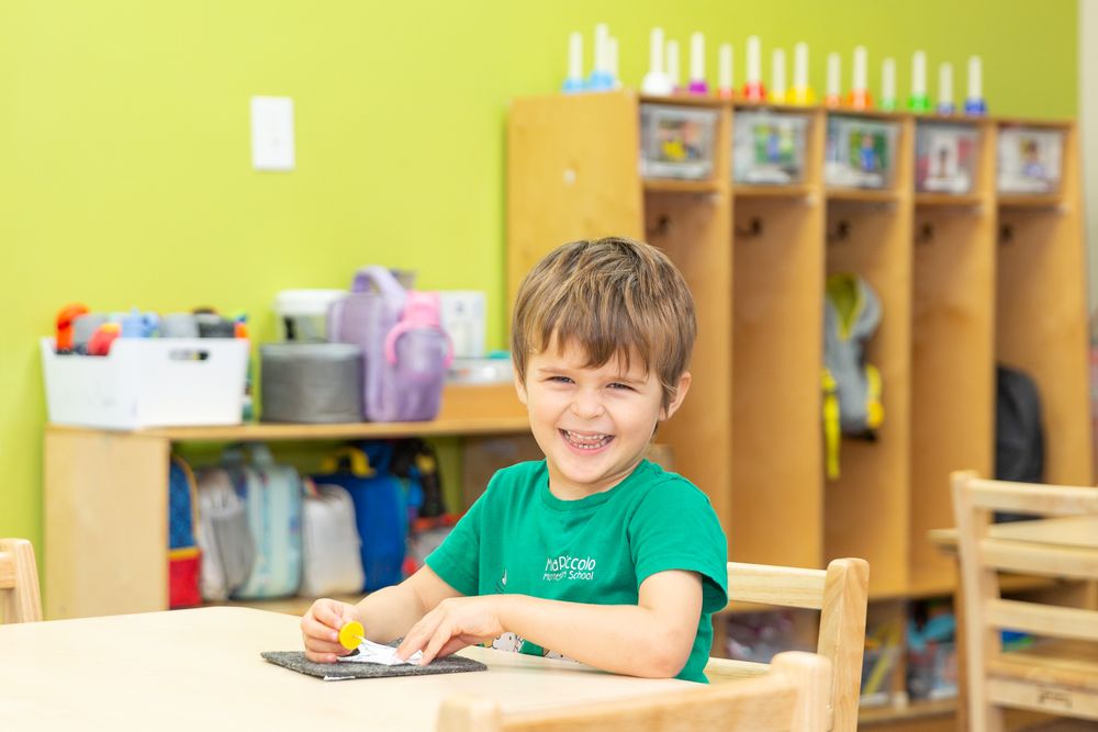 Bright yellow classroom interior with wooden storage cubbies along the wall. Happy kid enjoying activities.
Schools photography.