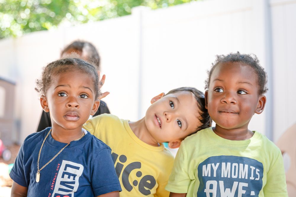 Children together at a school park wearing colorful t-shirts.
Schools photography.