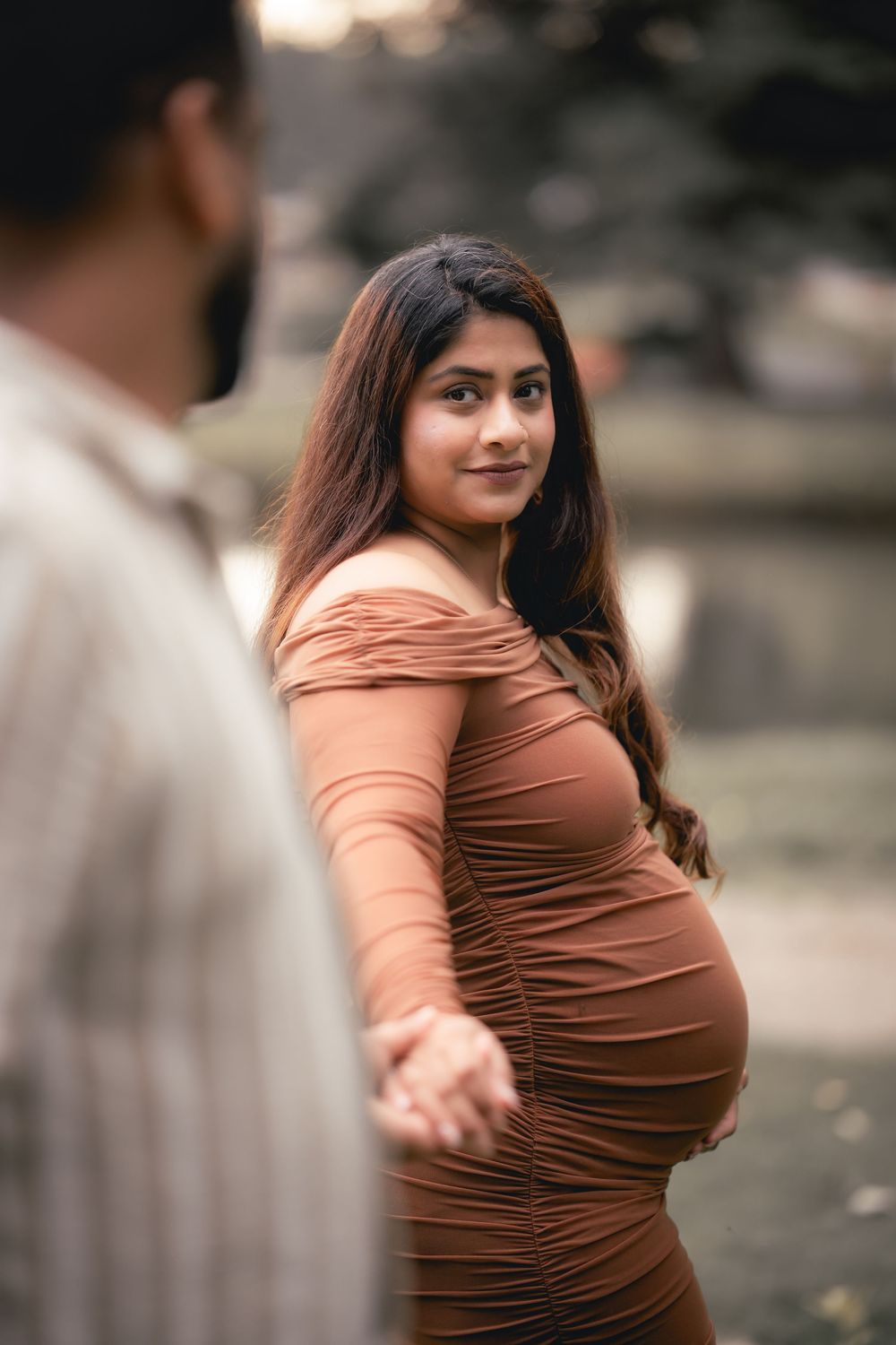 A woman in a brown dress poses playfully in a sequence of outdoor portrait shots with soft lighting and bokeh background.