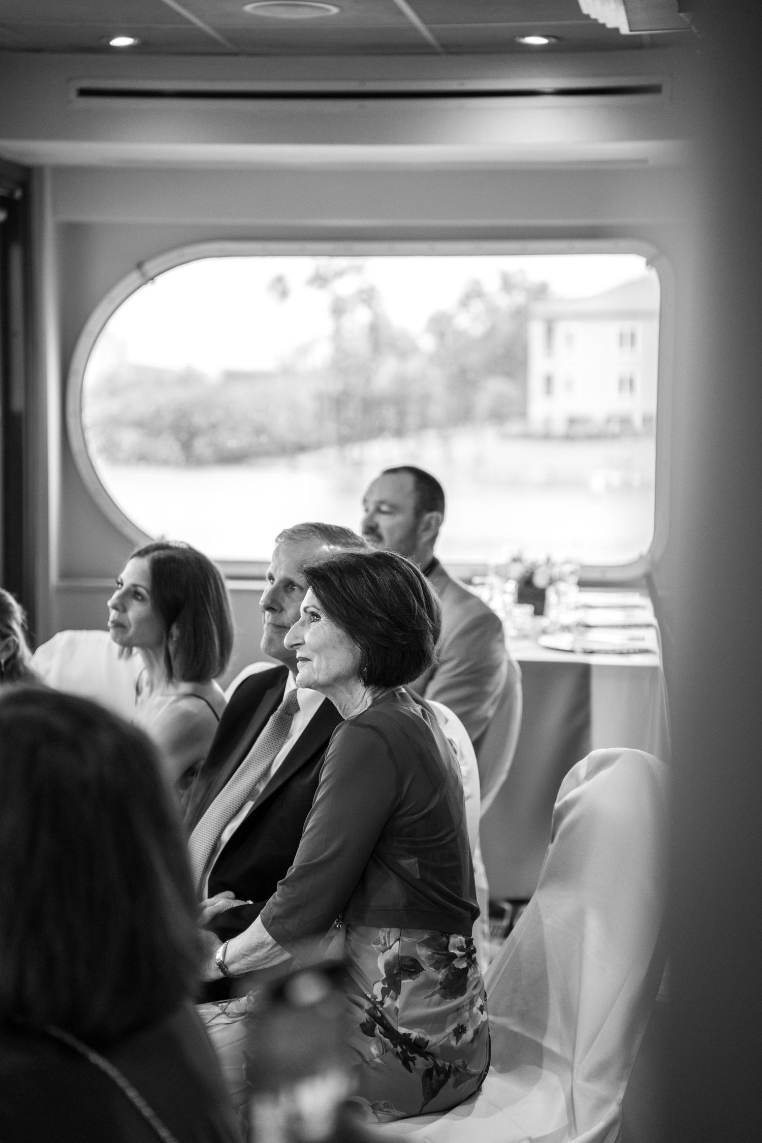 Guests enjoying the view from inside a boat during a wedding celebration.Micro wedding on Yacht StarShip in Tampa