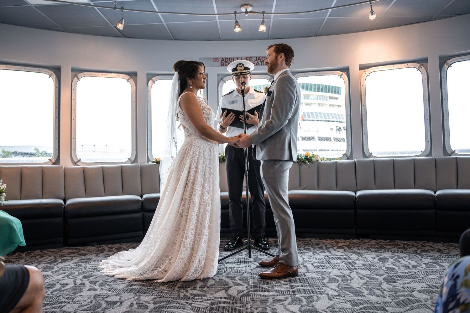 Interior of a wedding reception venue on a boat with large windows and elegant decor. Micro wedding on Yacht StarShip in Tampa