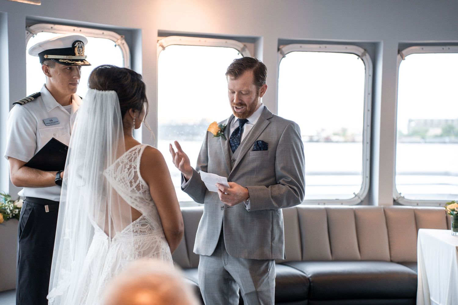 Wedding ceremony in progress aboard boat with captain and guests in attendance. Micro wedding on Yacht StarShip in Tampa