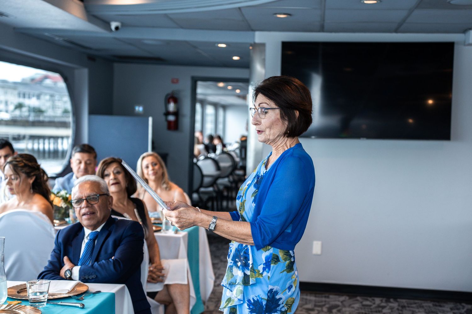 Wedding guests gathered in a modern venue with waterfront views during reception. Micro wedding on Yacht StarShip in Tampa