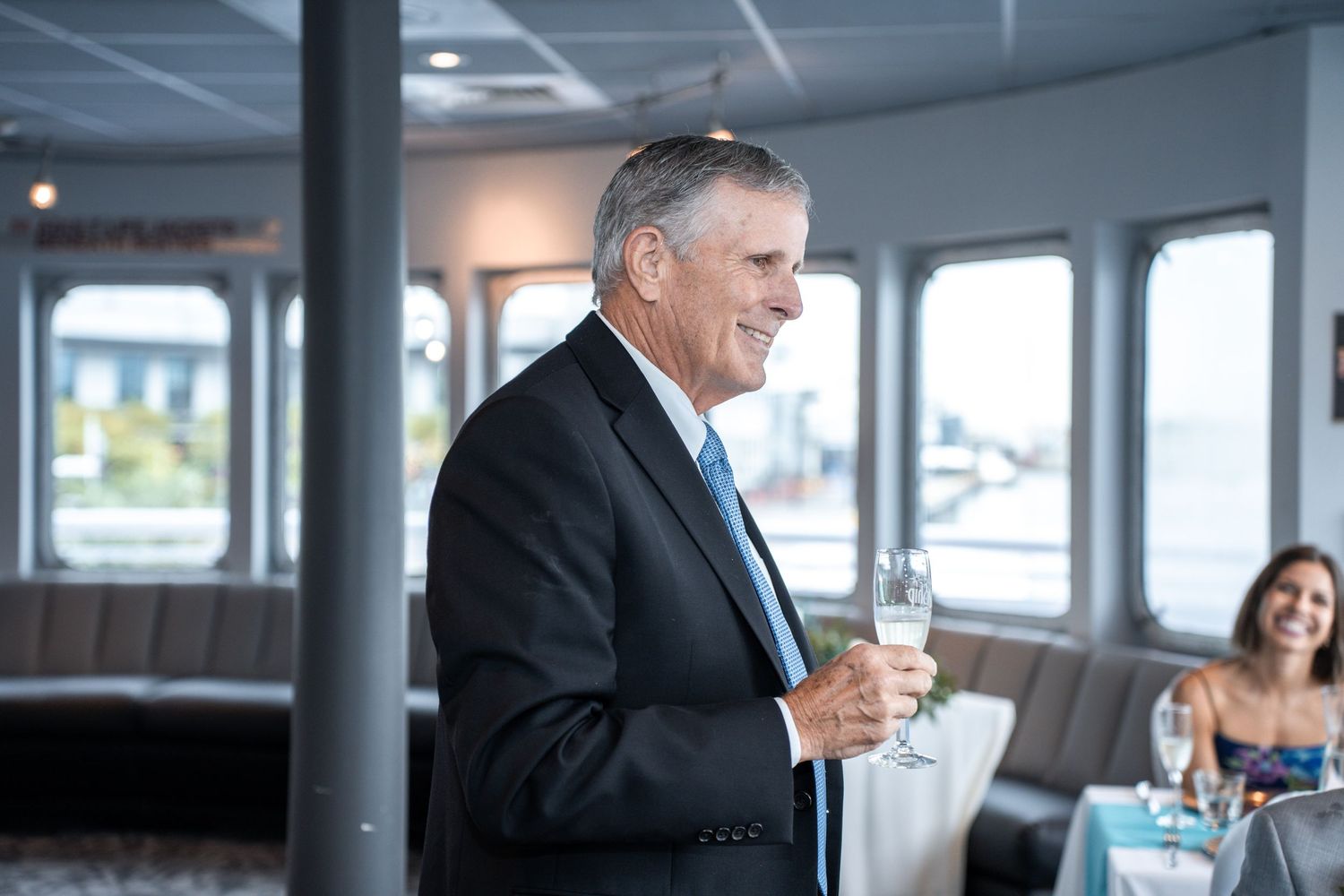 Wedding guests enjoying drinks and conversation aboard a boat with waterfront views. Micro wedding on Yacht StarShip in Tampa