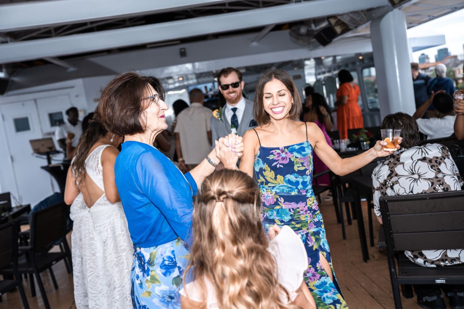 Wedding guests in summer attire enjoying festivities aboard a boat Yacht StarShip in Tampa Fl