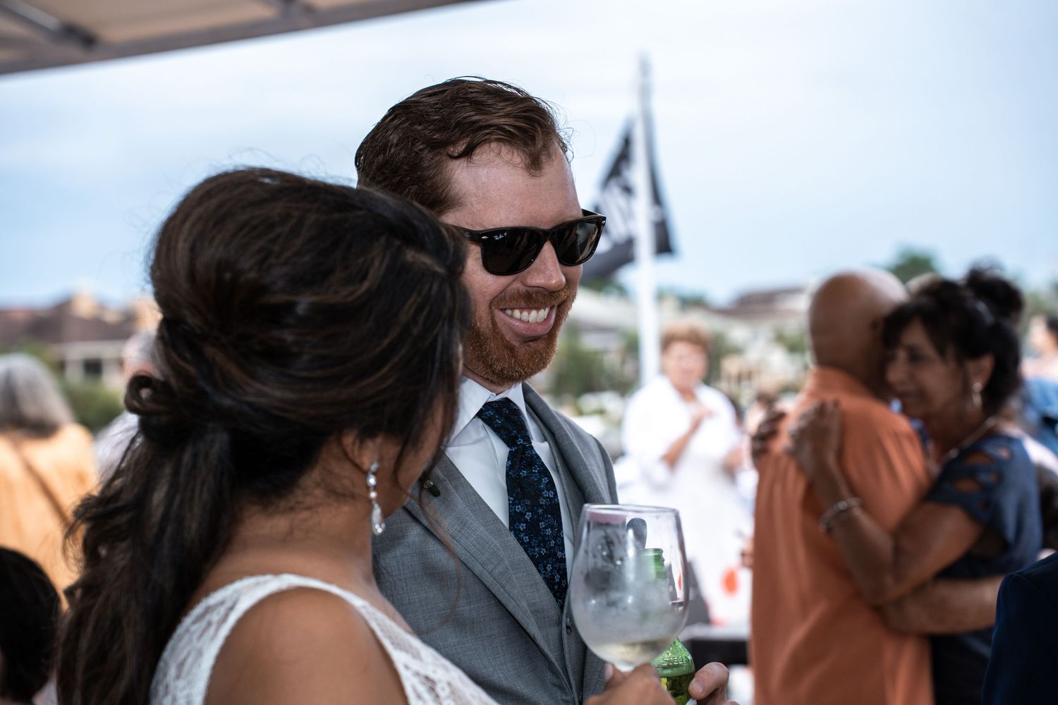 Wedding guests mingling and socializing on the deck of a boat during a sunny day celebration Yacht StarShip in Tampa Fl