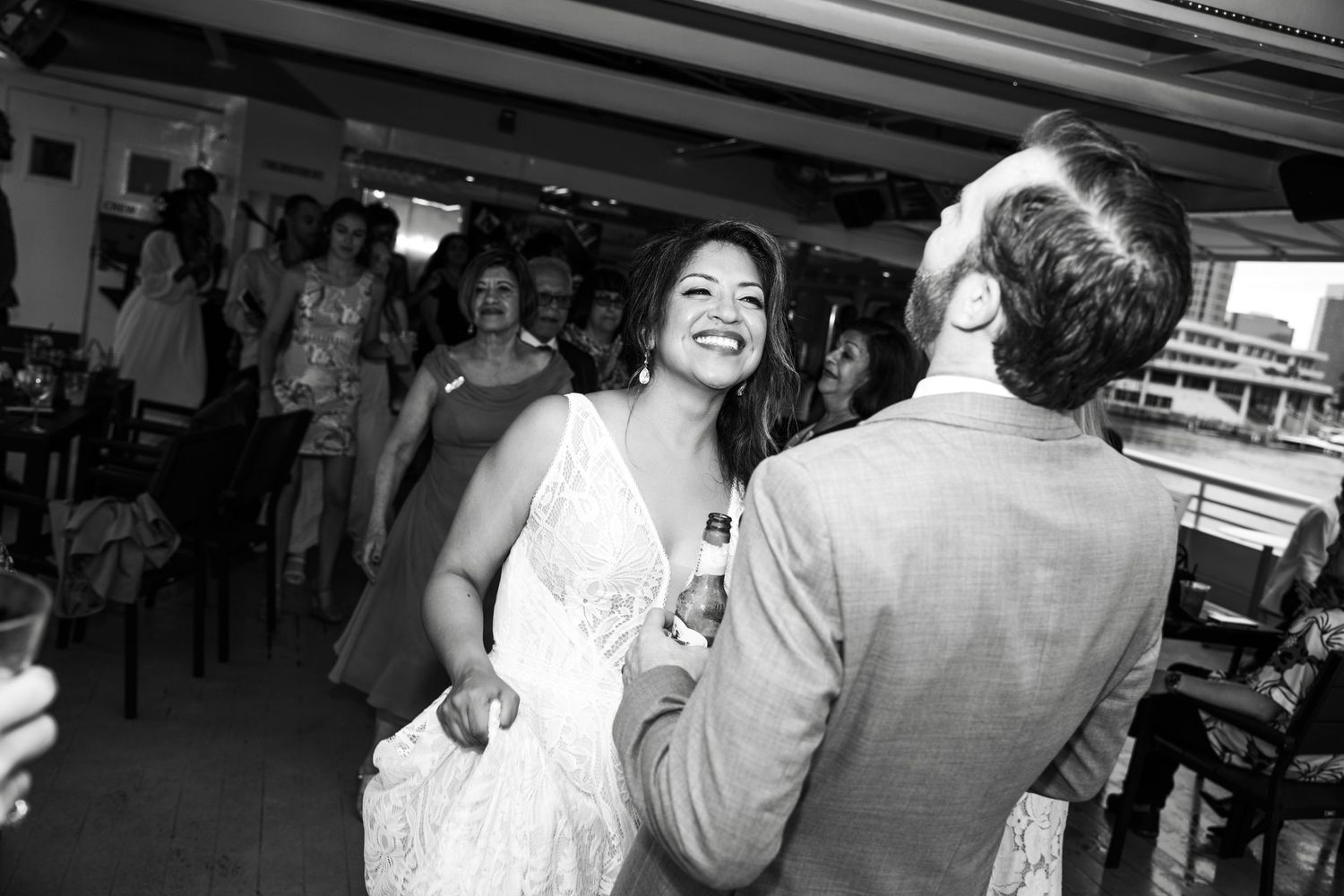 Black and white photo of guests dancing and celebrating at a boat party reception Yacht StarShip in Tampa Fl