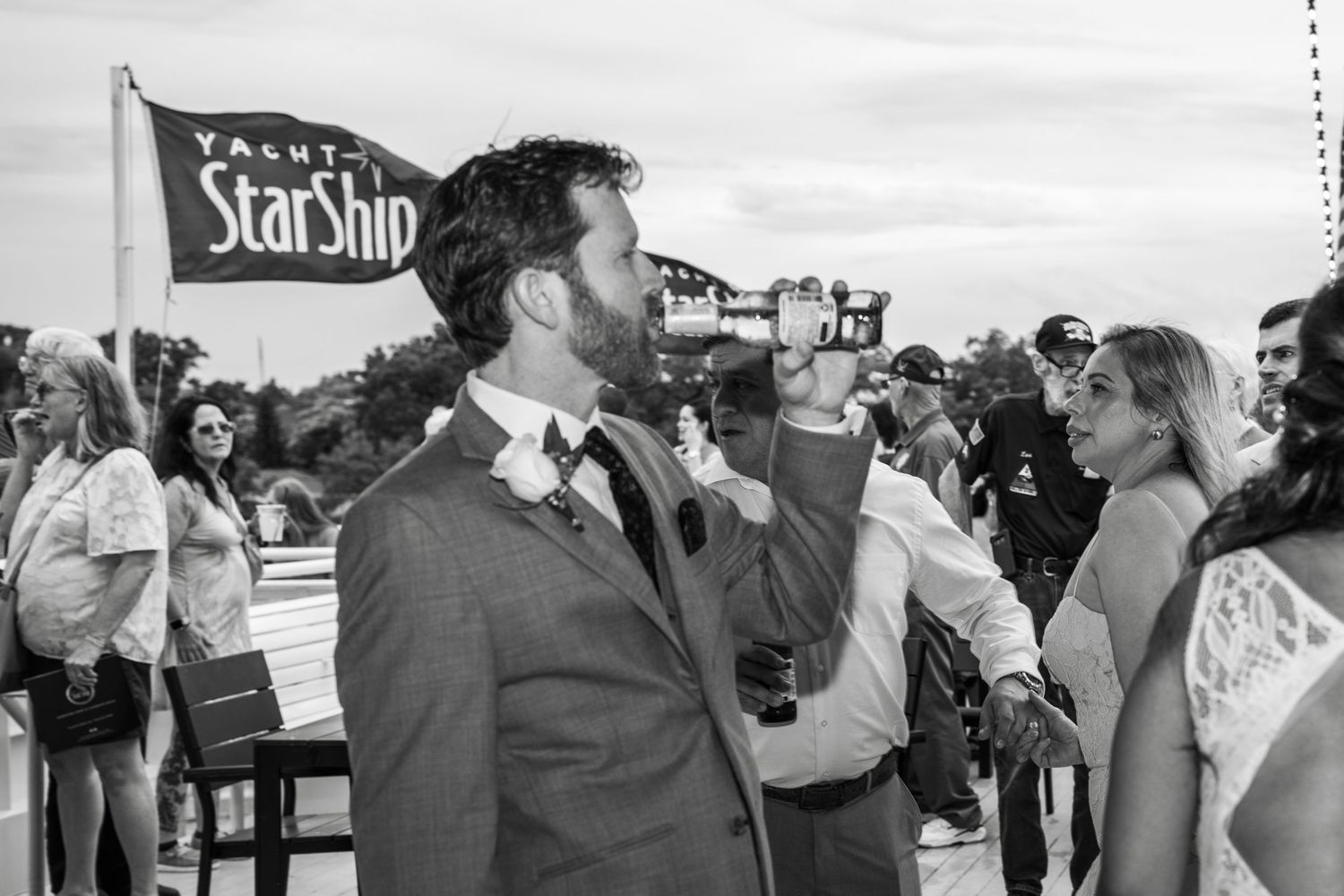Black and white photo of wedding guests mingling and socializing at outdoor reception Yacht StarShip in Tampa Fl