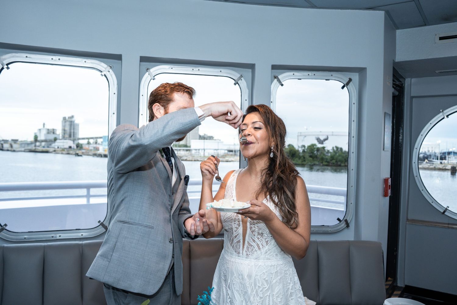 Wedding celebration inside a modern venue with large windows overlooking the water Yacht StarShip in Tampa Fl