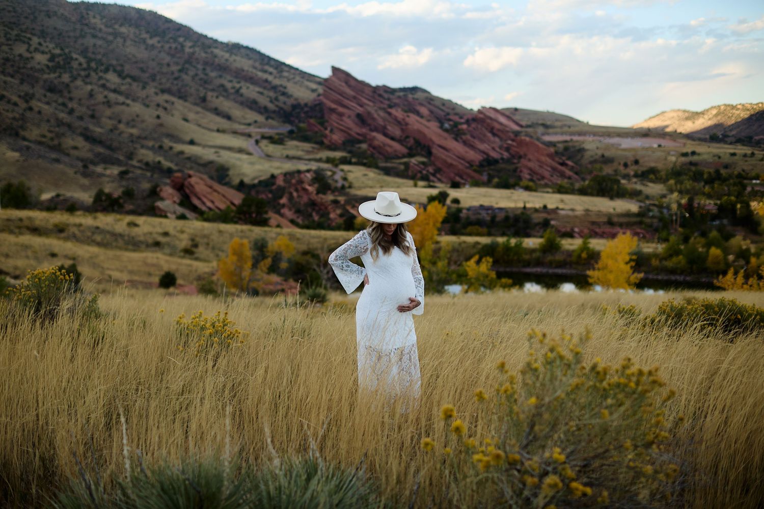 Maternity photo of expectant mother in lace dress at Mt Falcon East Denver Colorado